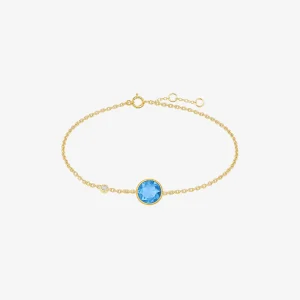 Feines goldfarbenes Armband mit rundem blauem Kristall als Mittelpunkt sowie kleinem weißen Zirkonia-Akzent und verstellbarem Kettenverschluss