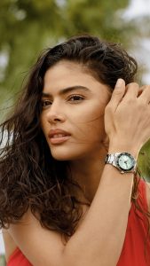 Person trägt eine Tissot Seastar Taucheruhr mit türkisfarbenem Zifferblatt und Edelstahlarmband im Outdoor-Lifestyle-Motiv